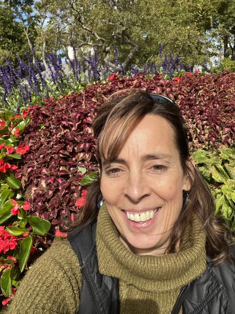 Sheryl stands in field of flowers